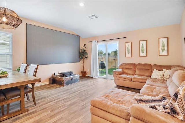 living room featuring light hardwood / wood-style flooring and lofted ceiling