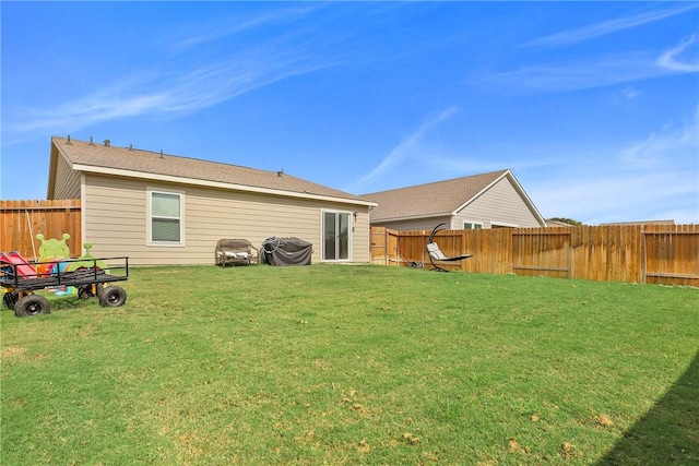 rear view of property featuring a lawn