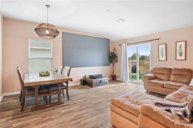 living room featuring light hardwood / wood-style flooring and lofted ceiling