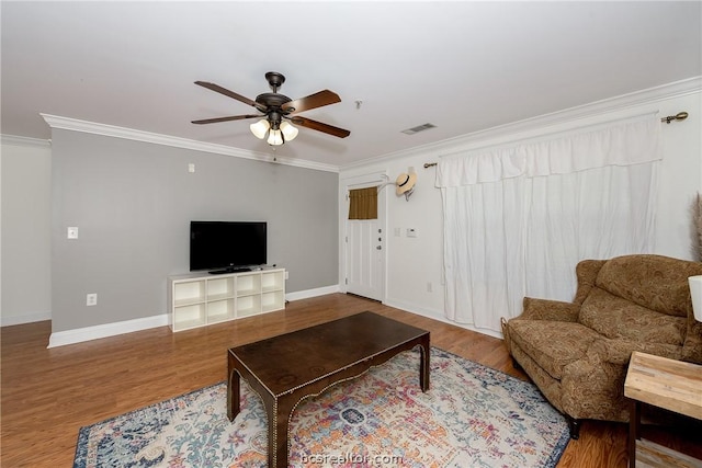 living room with ceiling fan, ornamental molding, and hardwood / wood-style flooring