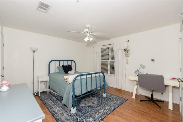 bedroom with hardwood / wood-style flooring and ceiling fan