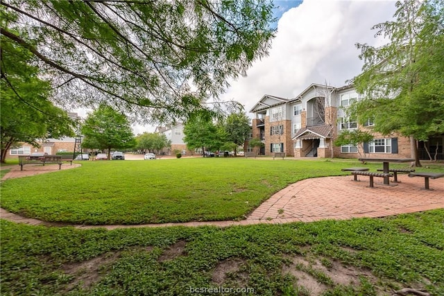 view of home's community with a lawn