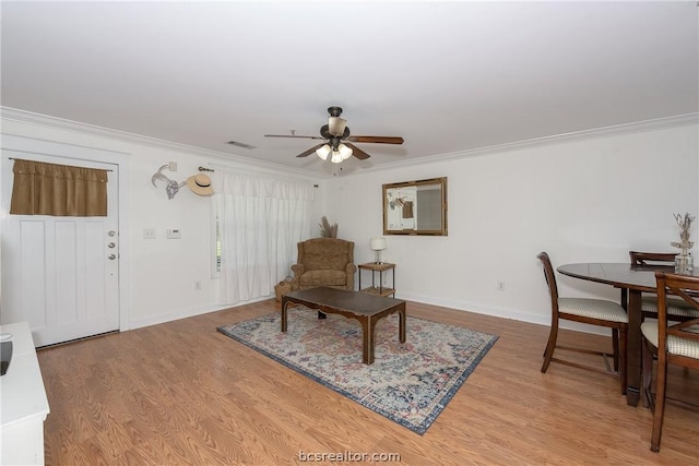 interior space featuring ceiling fan, light hardwood / wood-style floors, and ornamental molding