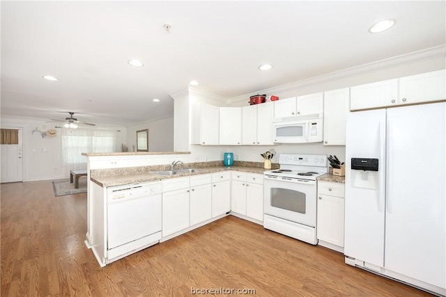 kitchen with sink, ornamental molding, white appliances, and light wood-type flooring