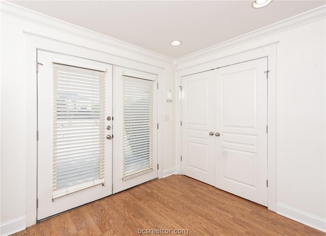 entryway featuring light hardwood / wood-style flooring, french doors, and ornamental molding