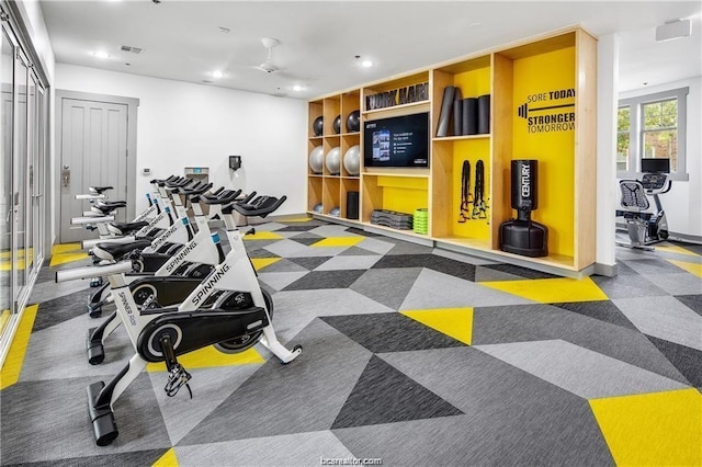 exercise room featuring carpet flooring and ceiling fan