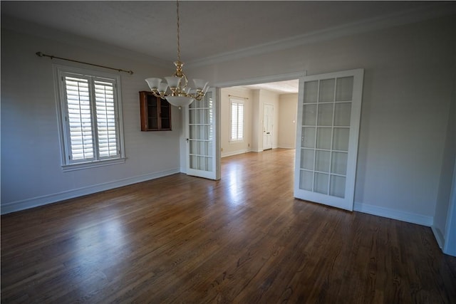 unfurnished dining area featuring french doors, a healthy amount of sunlight, dark hardwood / wood-style floors, and ornamental molding