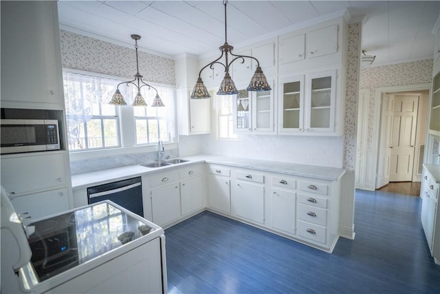 kitchen with pendant lighting, sink, dark hardwood / wood-style flooring, white cabinetry, and stainless steel appliances