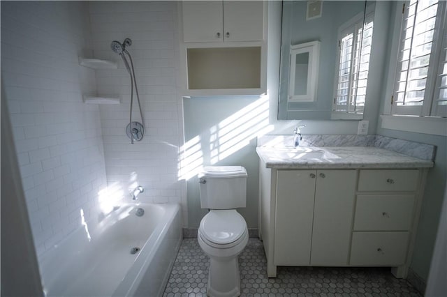 full bathroom featuring tile patterned flooring, vanity, toilet, and tiled shower / bath combo