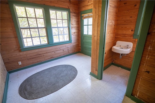 bathroom featuring wooden walls