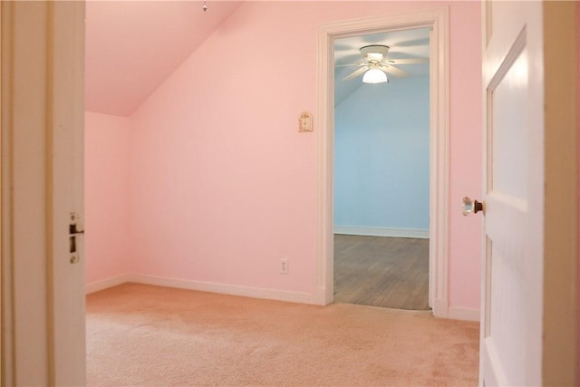 additional living space featuring ceiling fan, light colored carpet, and lofted ceiling