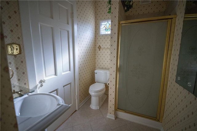 bathroom featuring tile patterned flooring, toilet, and walk in shower