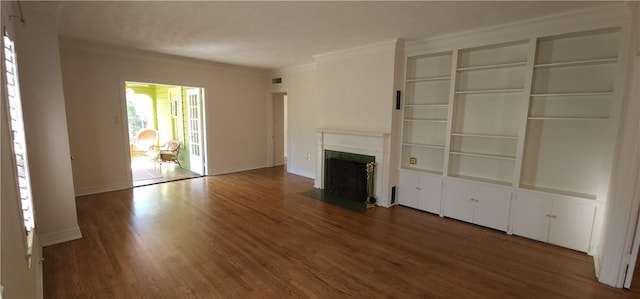 unfurnished living room featuring crown molding and dark hardwood / wood-style flooring