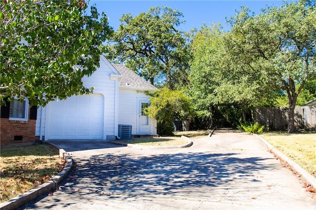 exterior space featuring a garage and central air condition unit