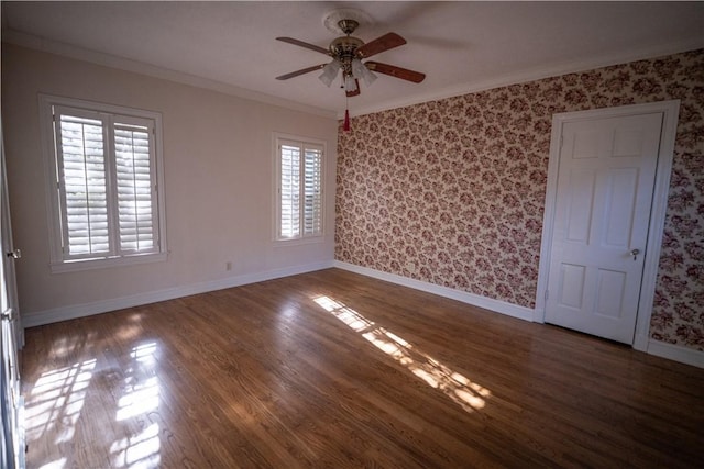 spare room with dark hardwood / wood-style floors, ceiling fan, and ornamental molding