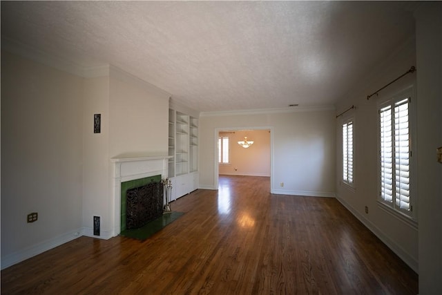 unfurnished living room featuring a chandelier, a textured ceiling, dark wood-type flooring, and a healthy amount of sunlight