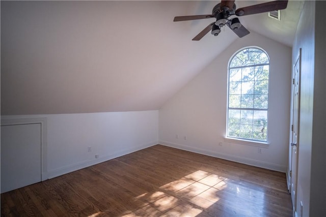 additional living space with hardwood / wood-style flooring, vaulted ceiling, and ceiling fan