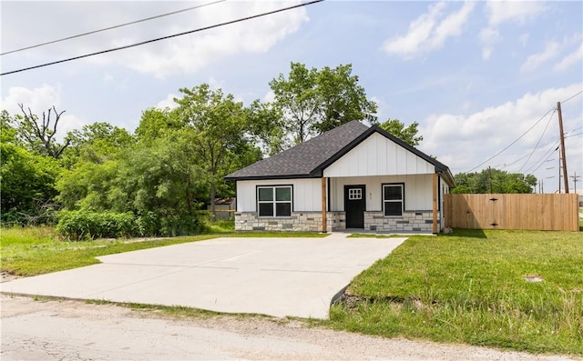 611 Levy St, Navasota, TX 77868 - view of front of house featuring stone siding and roof with shingles