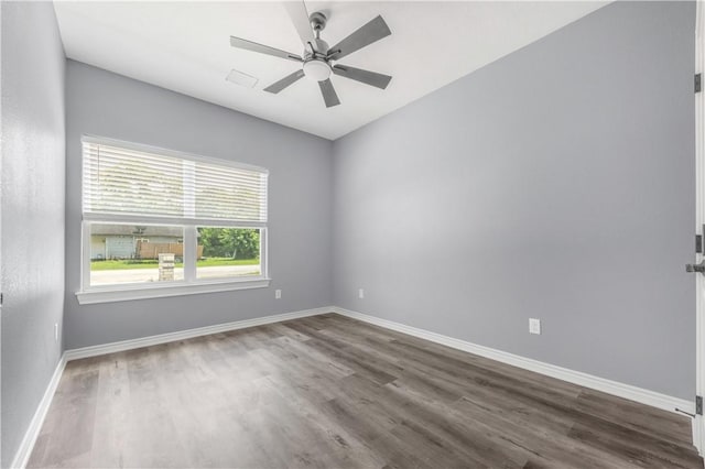 611 Levy St, Navasota, TX 77868 - empty room with dark wood-type flooring, baseboards, and a ceiling fan