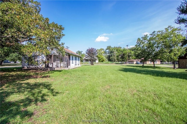 view of yard featuring a sunroom