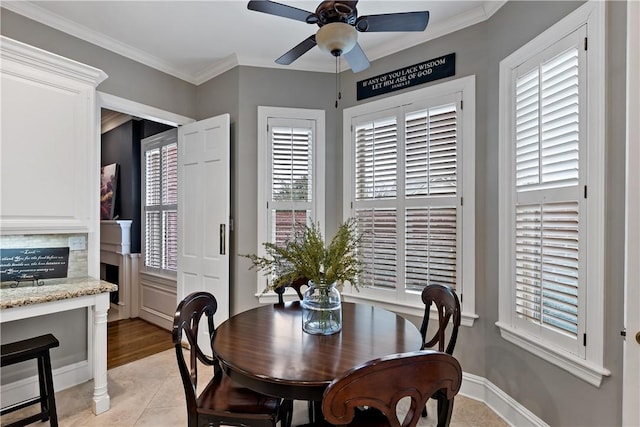 dining space with ornamental molding, light tile patterned floors, and ceiling fan