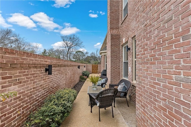 view of side of home with a patio