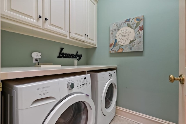 laundry area with cabinets and washer and clothes dryer