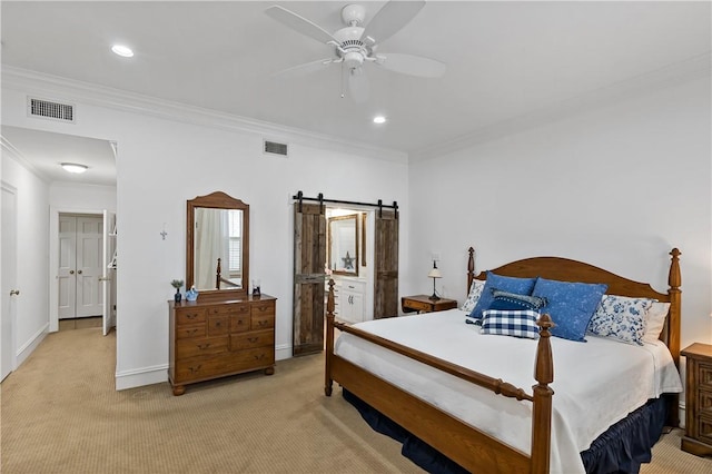 bedroom featuring crown molding, light colored carpet, a barn door, and ceiling fan