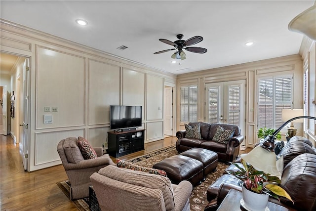 living room with hardwood / wood-style floors, ornamental molding, french doors, and ceiling fan