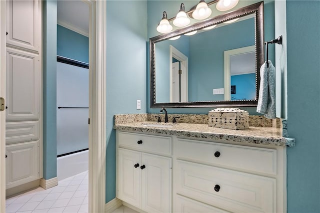 bathroom featuring enclosed tub / shower combo and vanity