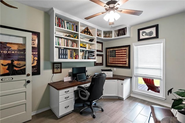office featuring baseboards, ceiling fan, and wood finished floors
