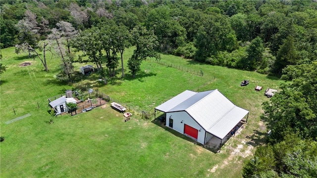 birds eye view of property featuring a view of trees