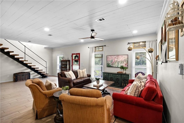 living area with recessed lighting, visible vents, wood finished floors, and stairs
