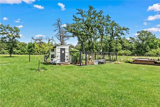 view of yard with a vegetable garden and an outdoor structure