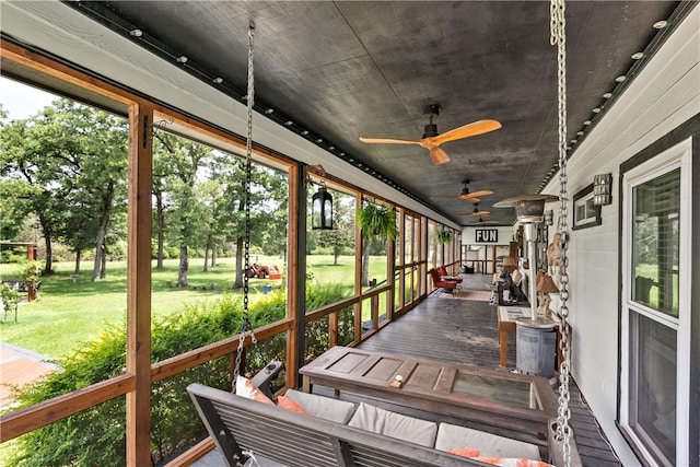 sunroom with a ceiling fan and a healthy amount of sunlight
