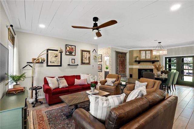 living area with a fireplace, ceiling fan, and recessed lighting