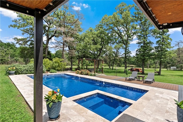 outdoor pool with a yard, an in ground hot tub, and a patio