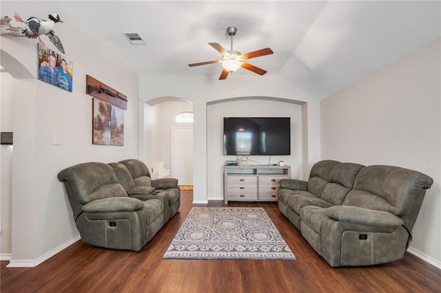 living area featuring visible vents, wood finished floors, arched walkways, and baseboards