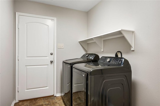 laundry area featuring baseboards, independent washer and dryer, and laundry area