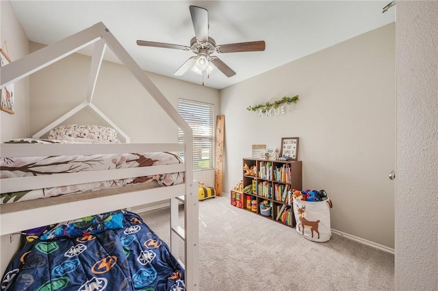 carpeted bedroom featuring baseboards and ceiling fan