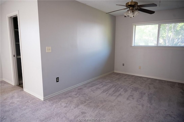 spare room featuring ceiling fan and light colored carpet