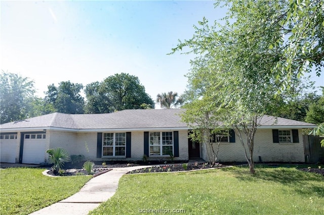 single story home with a garage and a front lawn