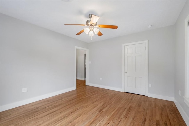 empty room with ceiling fan and light wood-type flooring