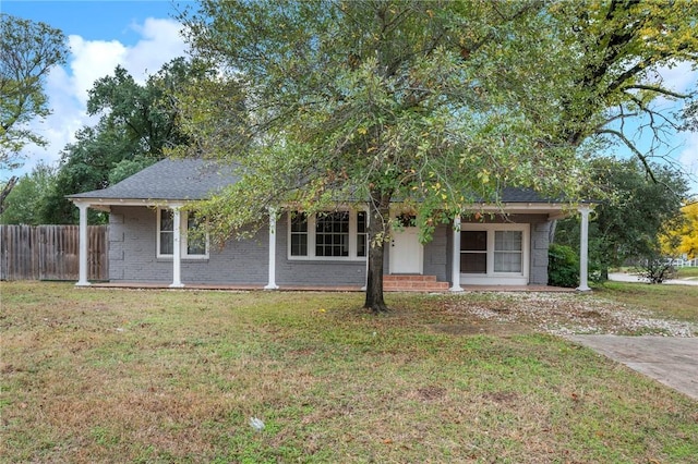 view of property hidden behind natural elements with a front yard