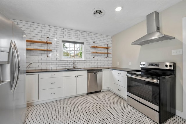 kitchen with white cabinets, sink, wall chimney exhaust hood, and stainless steel appliances