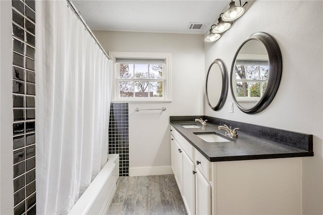 bathroom featuring vanity, wood-type flooring, and shower / bath combo with shower curtain