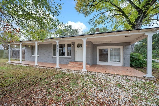 back of property with a porch