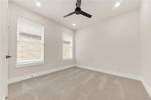 unfurnished room featuring ceiling fan and light colored carpet