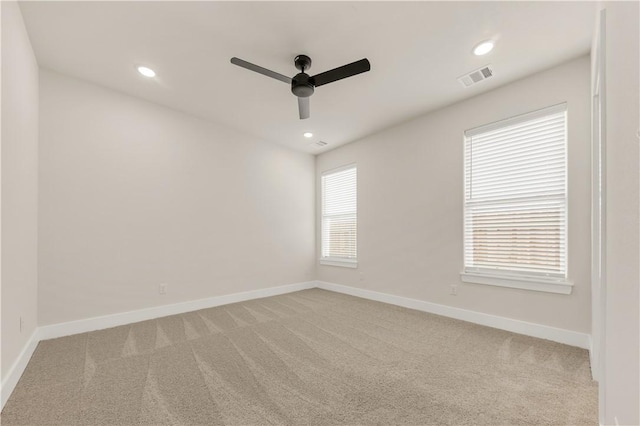 spare room with light carpet and ceiling fan