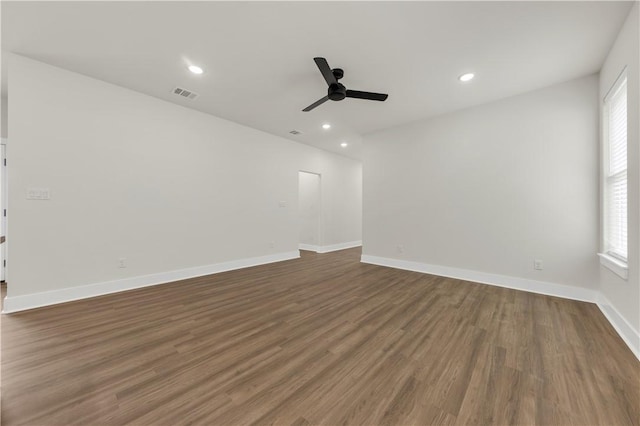 unfurnished room featuring dark wood-type flooring and ceiling fan